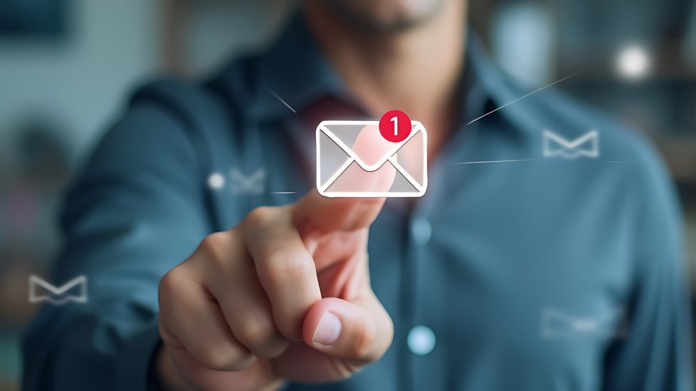 A business professional clicking on a digital email notification, representing the risk of phishing attacks and employee-targeted cyber threats.